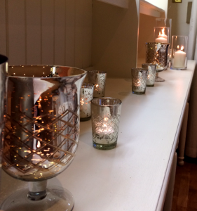A combination of glass cylinder vases and mercury glass vases and tealight holders lined each of the dressers. Mercury vases from belle-journee and glass cylinder vases from Eleanor Gail.